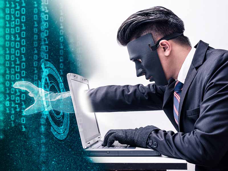 Information Theft - The abstract image of the hacker reach hand through a laptop screen for stealing the data