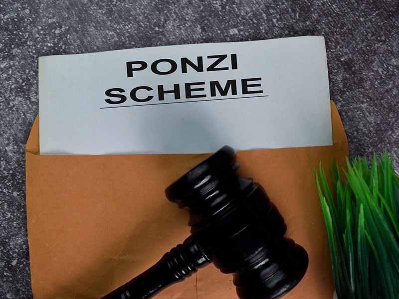 Ponzi Scheme text with document brown envelope