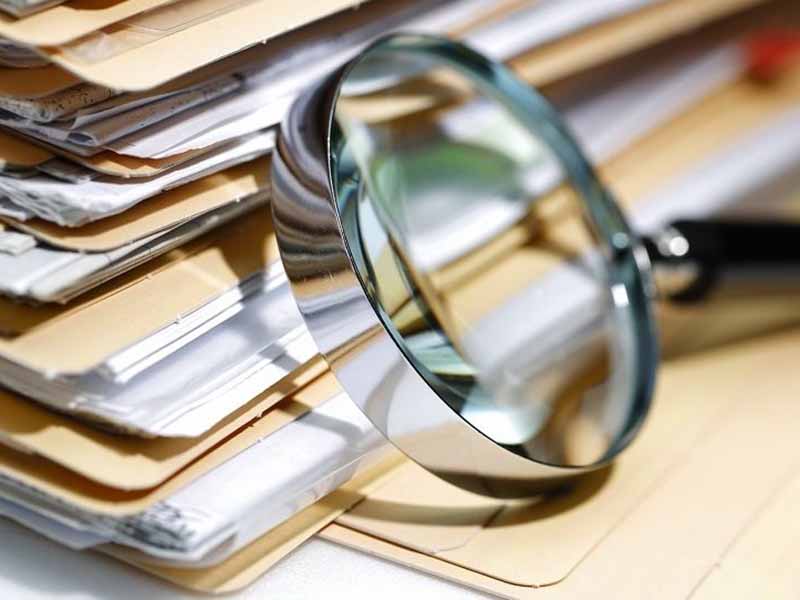 Third-Party Due Diligence: Before Engaging Third Parties - magnifying glass next to several document folders